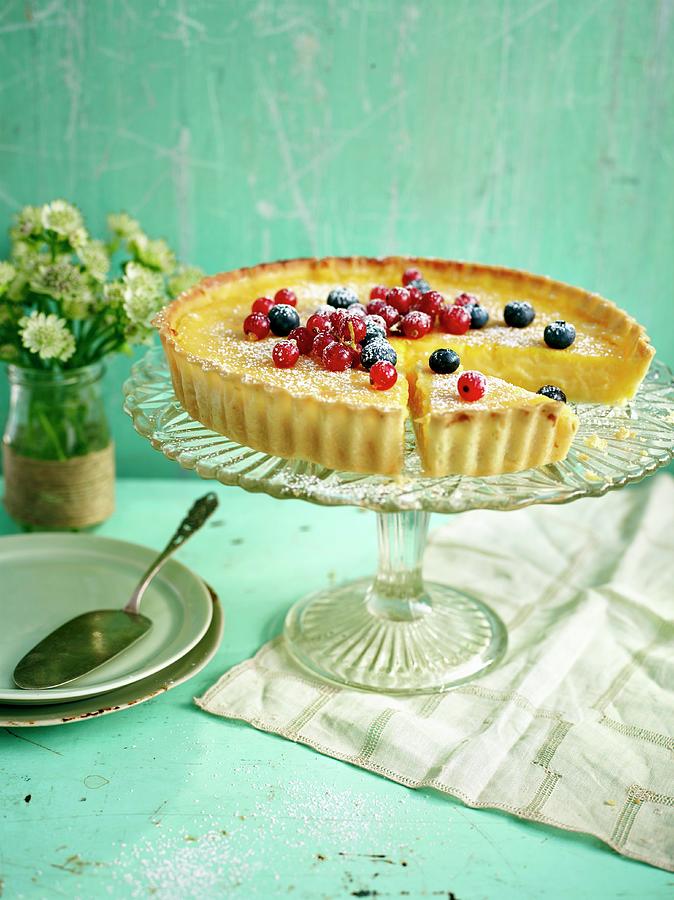 Lemon Tart Topped With Berries With A Slice Taken Out Photograph by Dan Jones