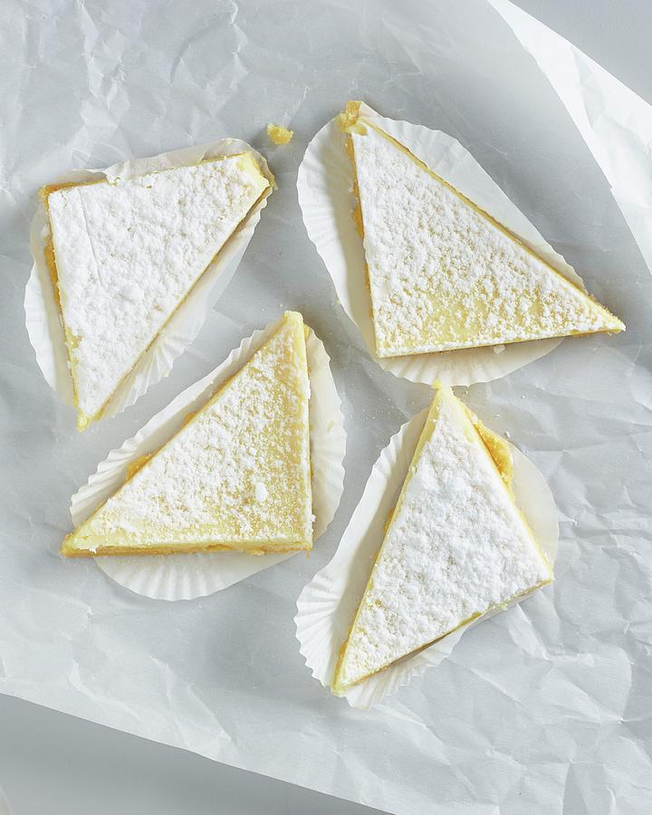 Lemon Tart Triangles With Icing Sugar On White Parchment Paper Photograph by Michael S. Harrison