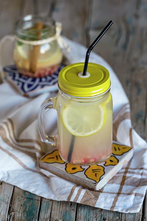 Lemonade With Fresh Lemon, Mint, Cinnamon And Quince On A Wooden Surface Photograph by Eduardo Lopez Coronado