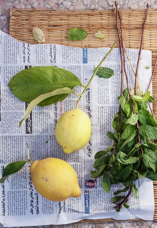 Lemons And Fresh Mint On A Piece Of Newspaper seen From Above Photograph by Anna Grudzinska-sarna