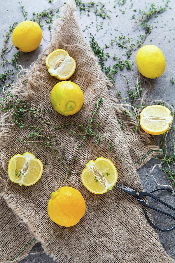 Lemons And Thyme On A Linen Cloth Photograph by Aniko Takacs