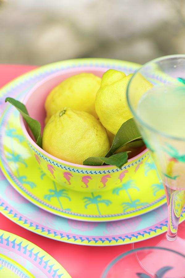 Lemons In Bowl On Colourful Plate Photograph by Winfried Heinze