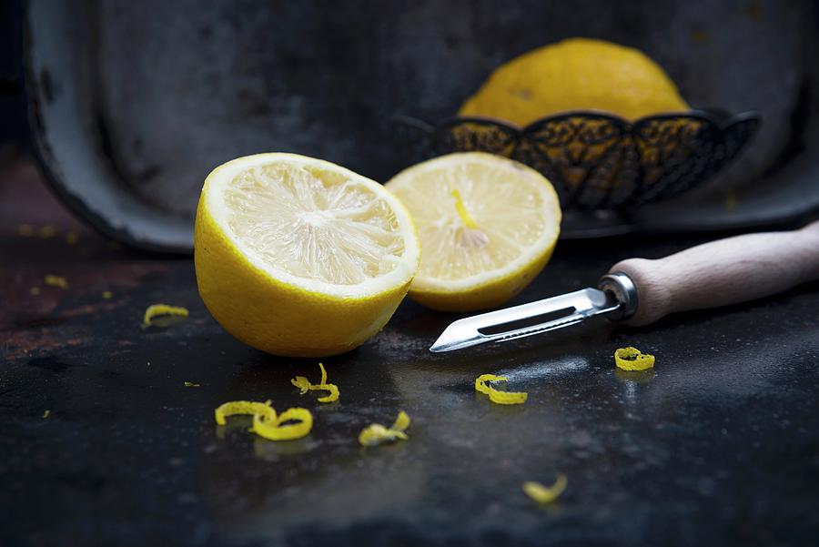 Lemons With Zest And A Vegetable Peeler Photograph by Kati Neudert