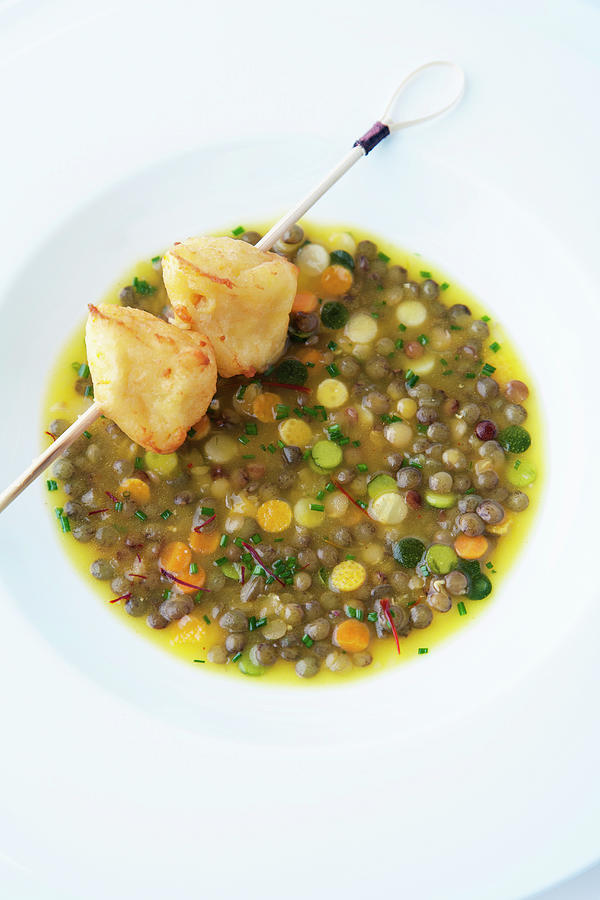 Lentil Soup With Orange And A Potato Skewer Photograph by Michael Wissing