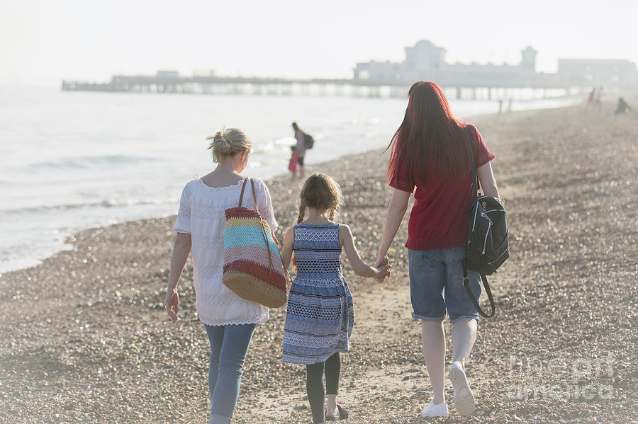 Lesbian Couple And Daughter Walking On Beach Photograph By Caia Image