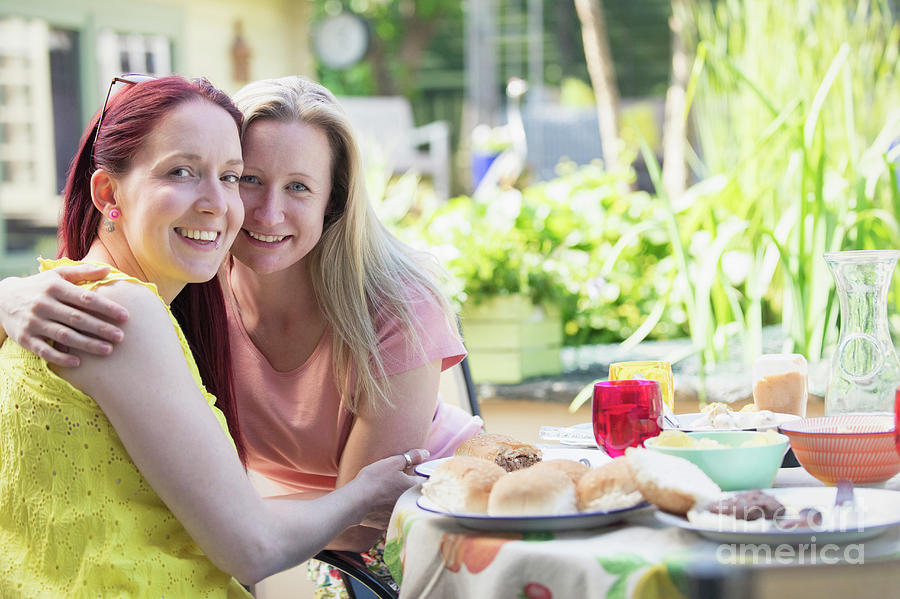 Lesbian Couple Enjoying Lunch On Patio Photograph By Caia Imagescience 