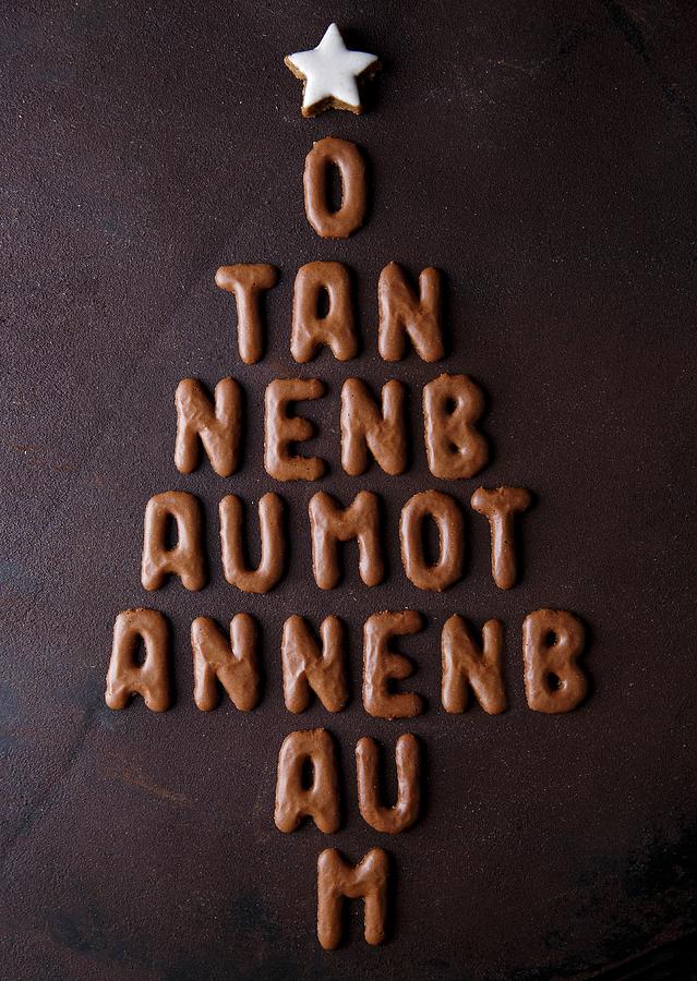 Letter-shaped Biscuits Arranged In The Shape Of A Christmas Tree, Reading o Tannenbaum And Topped With A Star Photograph by Mona Binner Photographie