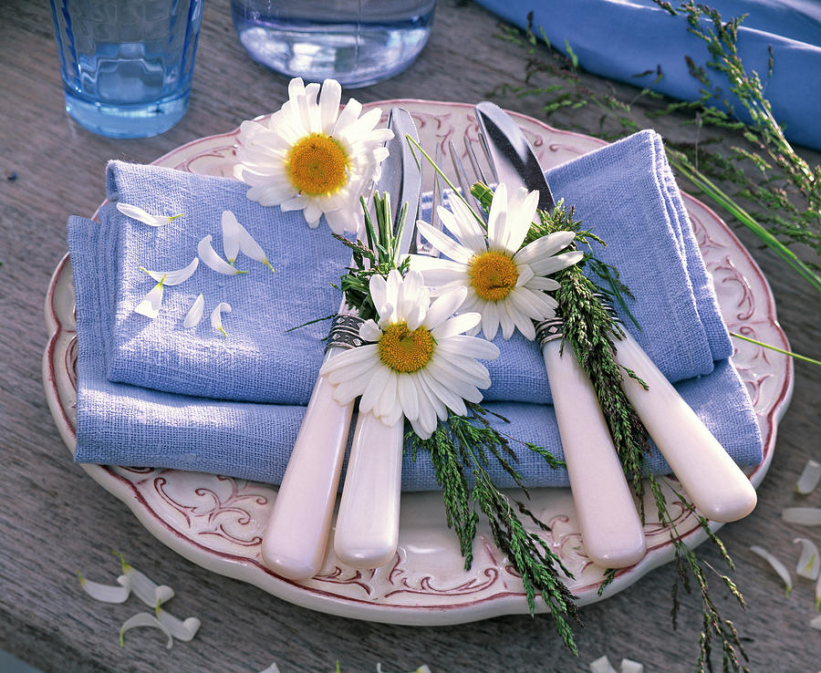 Leucanthemum Flowers And Grasses On Blue Cloth Napkins Photograph by Friedrich Strauss