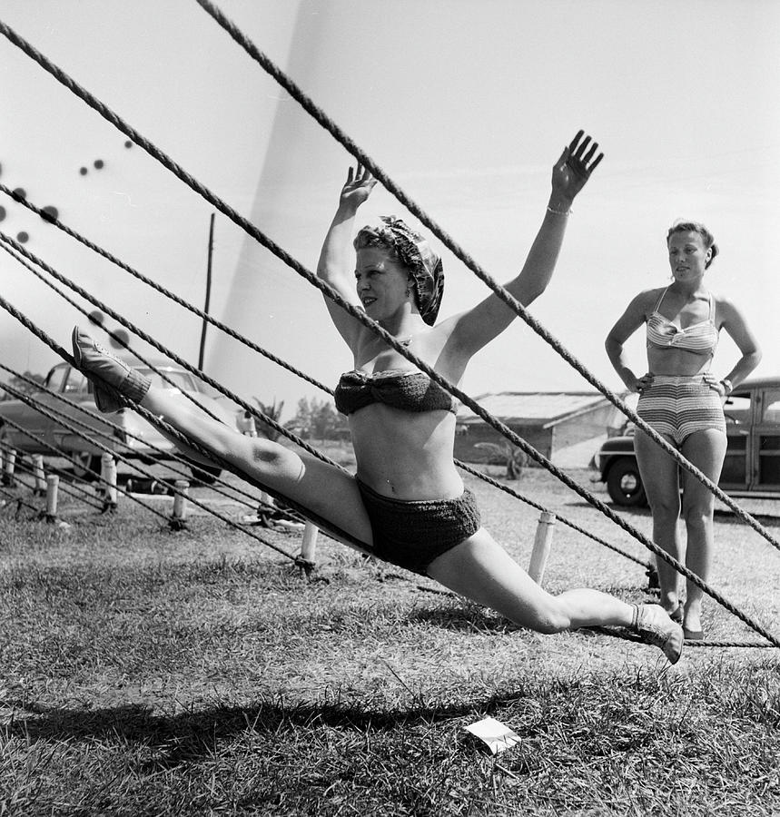 Rope Photograph - Life Visits the Circus in Florida- Performer on ropes by Nina Leen