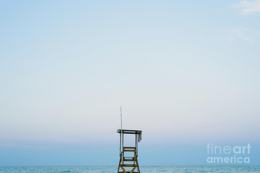 Lifeguard watchtower on the beach at sunset. Photograph by Joaquin Corbalan