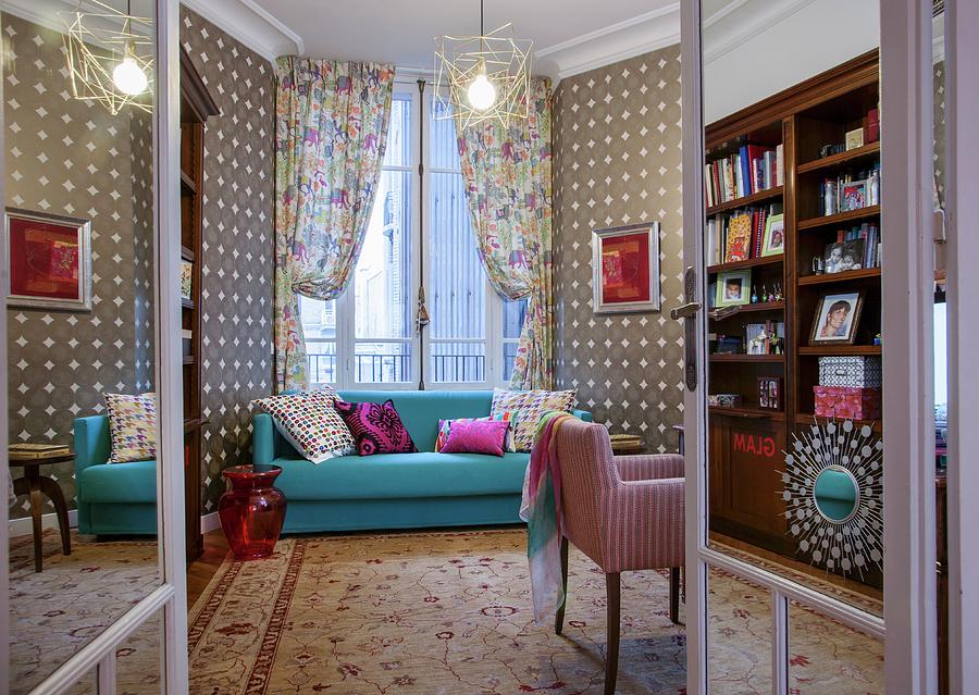 Light Blue Couch In Front Of Window With Draped Curtains And Patterned Wallpaper In Eclectic Interior Seen Through Open Double Doors Photograph by Christophe Madamour
