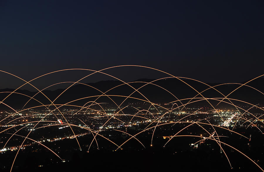 Light Trails Over City Photograph by Paul Taylor