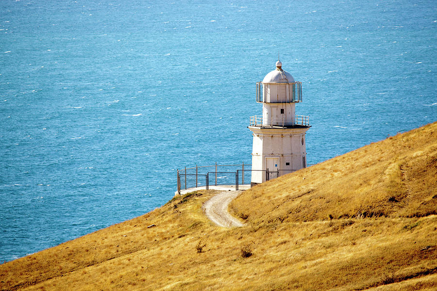 Lighthouse At The Edge Of Meganom Cape Photograph by Mordolff