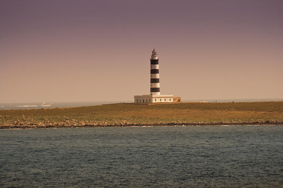 Lighthouse In Island At Sunset Photograph by Artur Debat