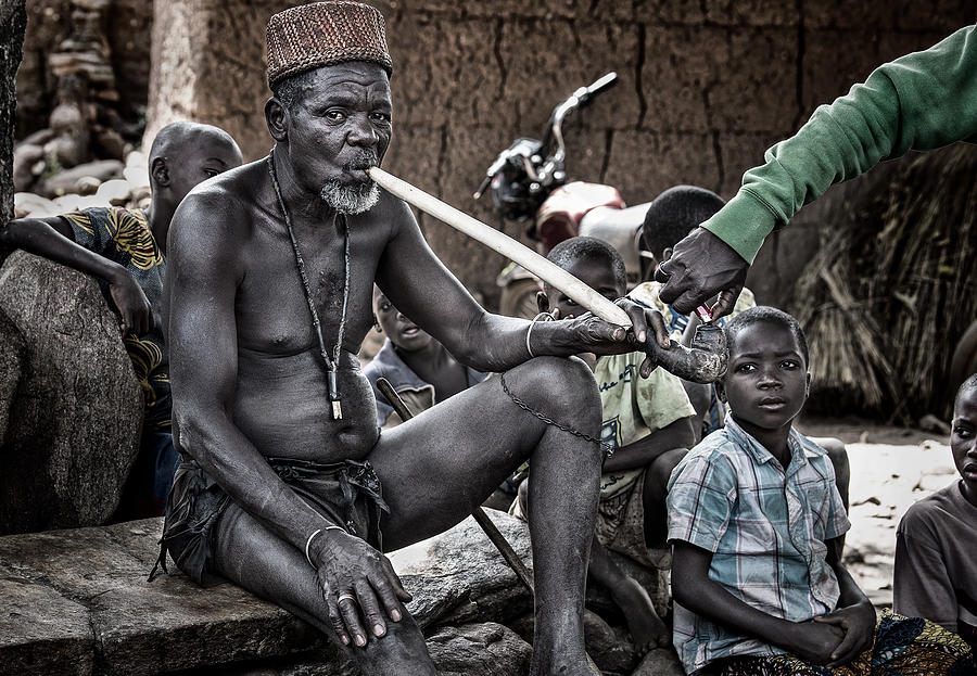 Lighting A Pipe To A Village Chief In Benin. Photograph by Joxe Inazio Kuesta Garmendia