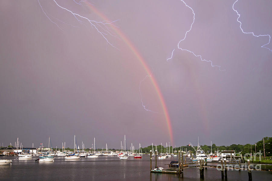 Lightnoing in a Rainbow Photograph by Butch Lombardi