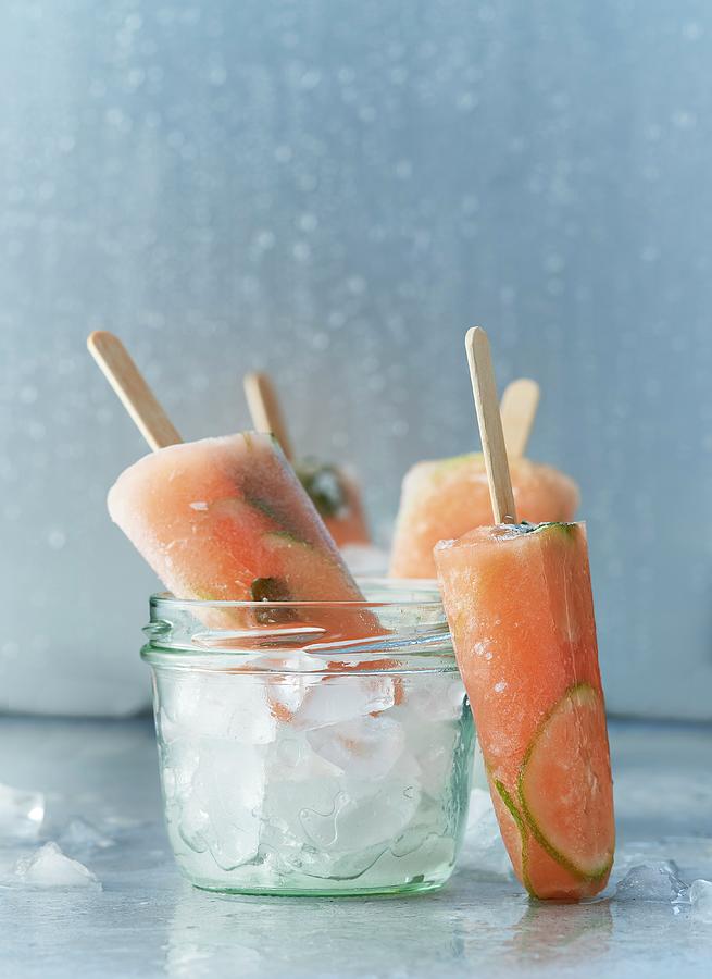 Lime And Papaya Ice Lollies With Mint Photograph by Stefan Schulte-ladbeck