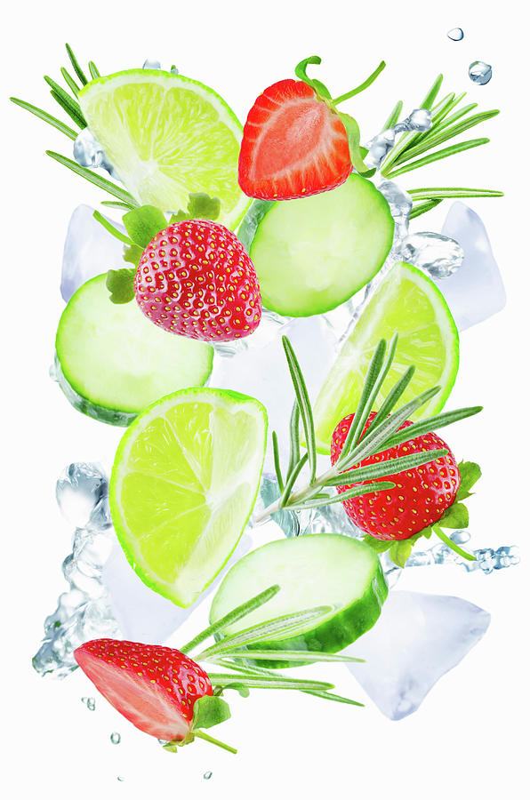 Lime, Cucumber, Strawberry And Rosemary Flying With Ices And Water Splash Photograph by Natasha Arz