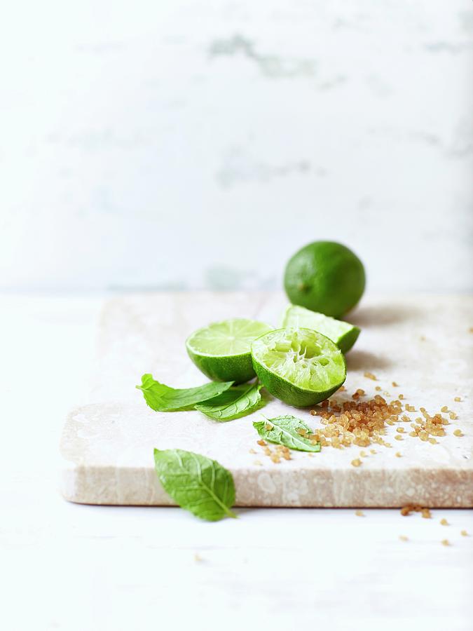 Limes, Brown Sugar And Mint Leaves For Making Mojitos Photograph by B.&.e.dudzinski