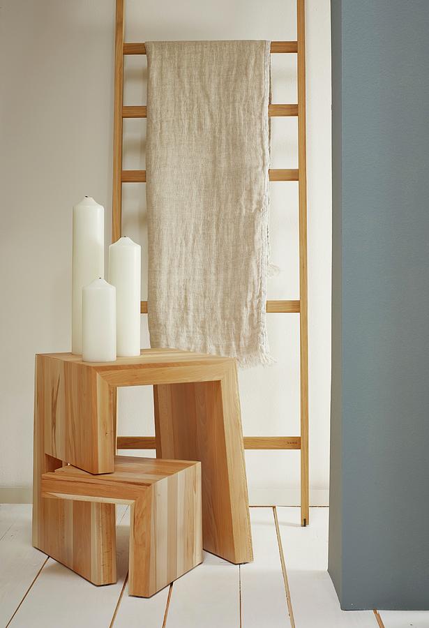 Linen Cloth Hung Over Wooden Ladder Used As Clothes Rack And Pillar Candles On Adjustable Wooden Stool Photograph by Michael Lffler