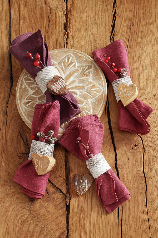 Linen Napkins With Napkin Rings And Names On Wooden Hearts Photograph by Stockfood Studios / Jan-peter Westermann