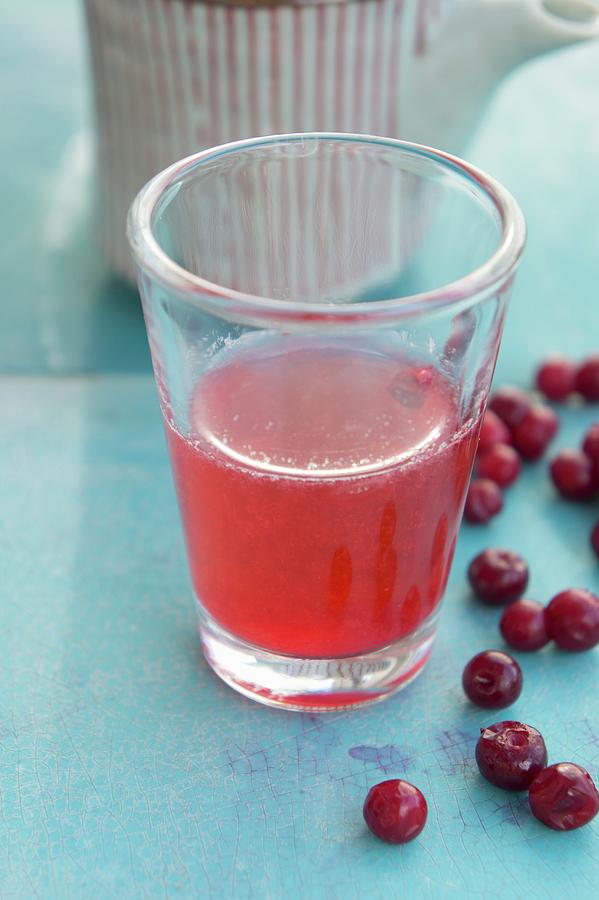 Lingonberry Juice In A Glass Photograph by Martina Schindler