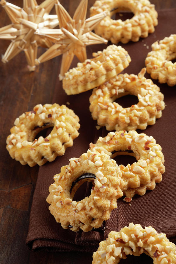 Linz Wreath Biscuits With Chopped Almonds And Redcurrant Jam Photograph by Teubner Foodfoto