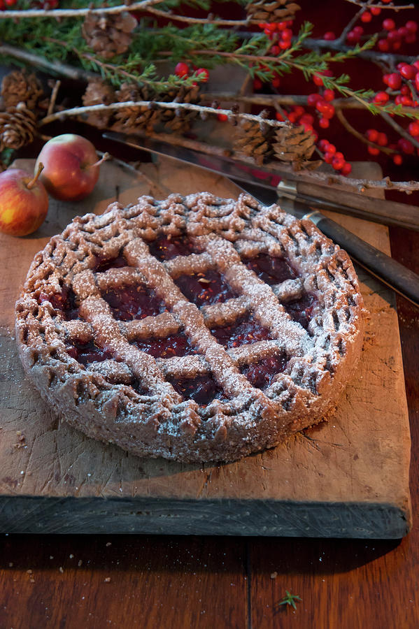 Linzer Torte nut And Jam Layer Cake And Bunches Of Holly Berries Photograph by Martina Schindler