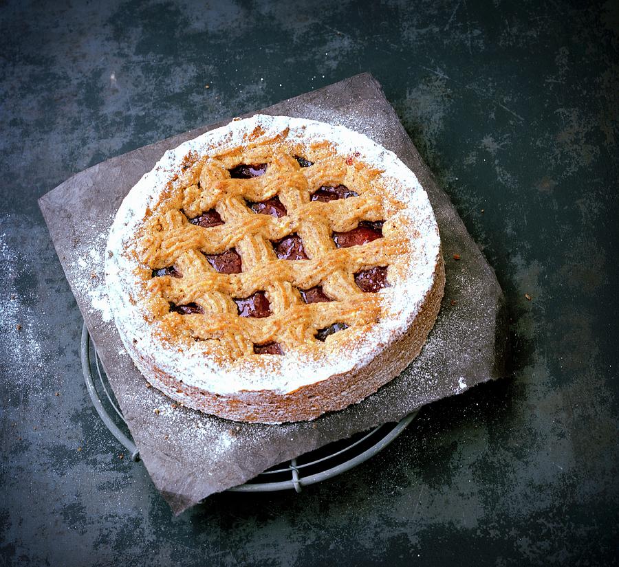 Linzertorte nut And Jam Layer Cake With Icing Sugar On A Piece Of Baking Paper Photograph by Matthias Hoffmann