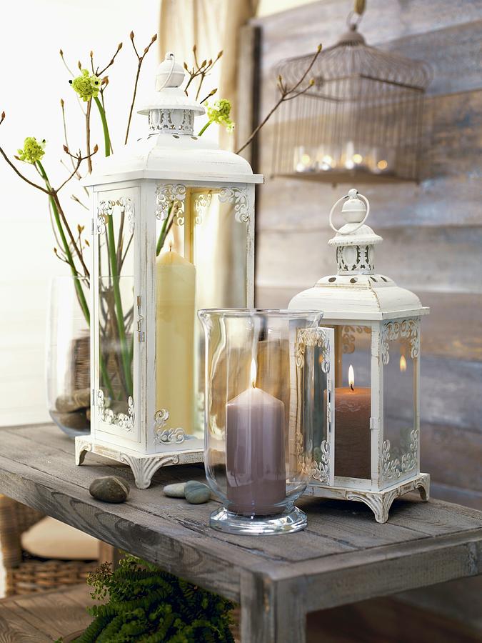 Lit Candle In Candle Lantern In Front Of Vintage-style Lanterns On Rustic Wooden Bench Photograph by Biglife