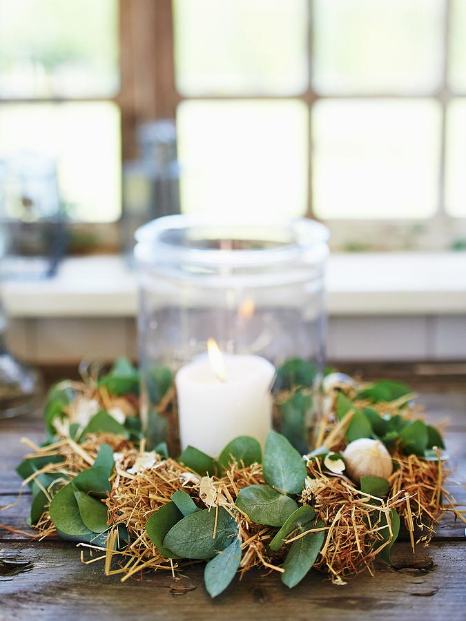 Lit Candle In Lantern Surrounded By Straw Easter Wreath Photograph by Hannah Kompanik