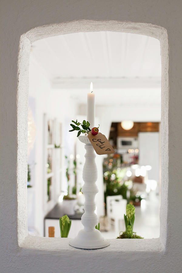 Lit Candles And Christmas Greetings In Aperture In Wall Photograph by Camilla Isaksson