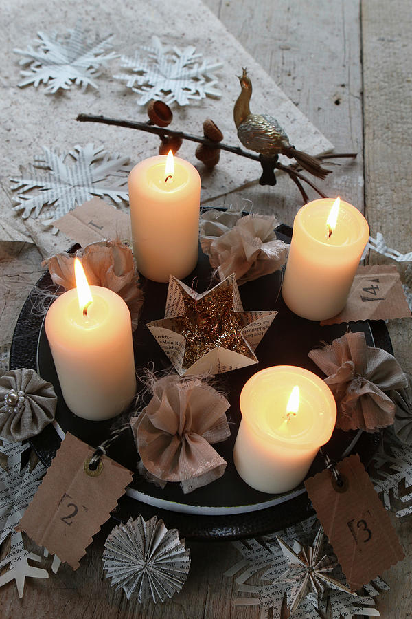 Lit Candles On Plate With Fabric Flowers And Paper Snowflakes Photograph by Regina Hippel
