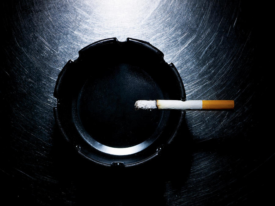 Lit Cigarette And Ashtray On Stainless Photograph by Ballyscanlon