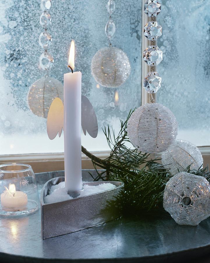 Lit White Candle In Festive, Silver And White, Glittering Ambiance Photograph by Matteo Manduzio