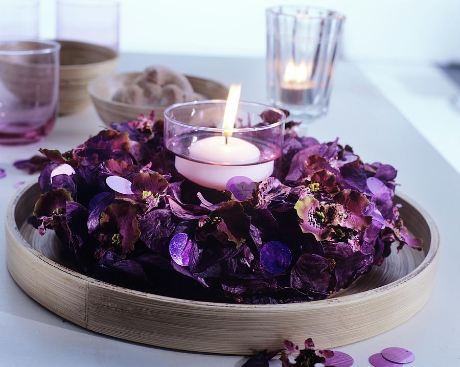 Lit, White Floating Candle In Wreath Of Purple Pot Pourri Photograph by Matteo Manduzio