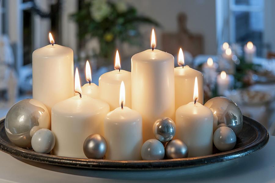 Lit White Pillar Candles Of Various Sizes And Silver Baubles On Tray Photograph by Moog & Van Deelen
