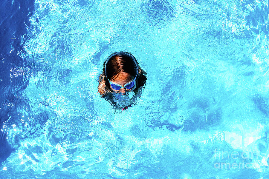 Little girl enjoying the good weather by bathing in her pool pla Photograph by Joaquin Corbalan
