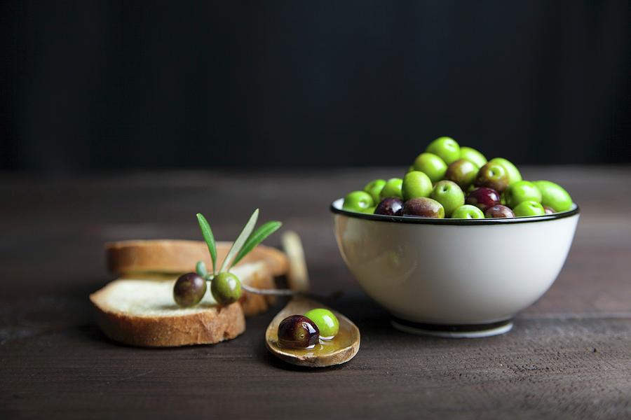 Lives In Olive Oil In A Porcelain Bowl And On Slices Of Bread On A Wooden Table Photograph by Riccardobruni