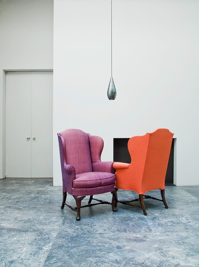 Lobby With Two Colorful Upholstered Armchairs And Modern Hanging Light Photograph by Bertrand Limbour