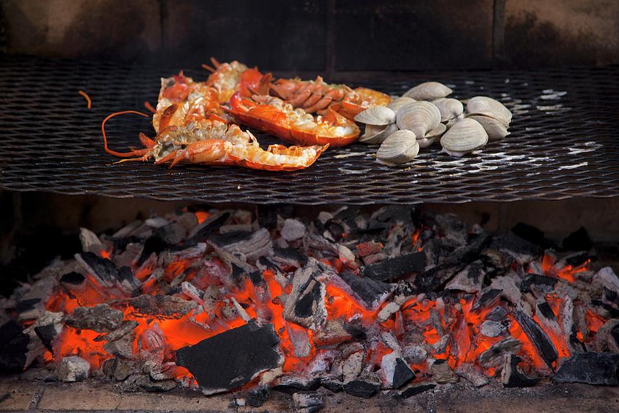 Lobster And Mussels Being Grilled Over An Open Fire Photograph by Andre Baranowski
