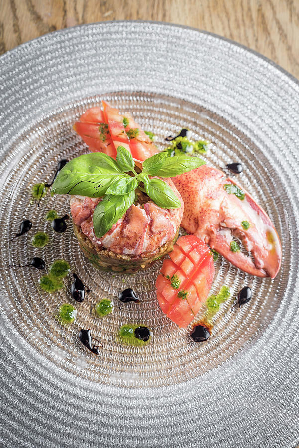 Lobster Meat Tartare With A Pesto And Balsamic Dressing And Tomato Garnished With Basil On A Glass Plate Photograph by Giulia Verdinelli Photography