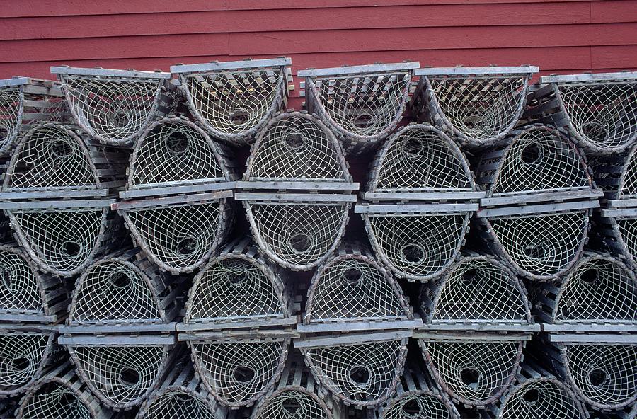 Lobster Traps Stacked Against Red Wall Photograph by Don Johnston