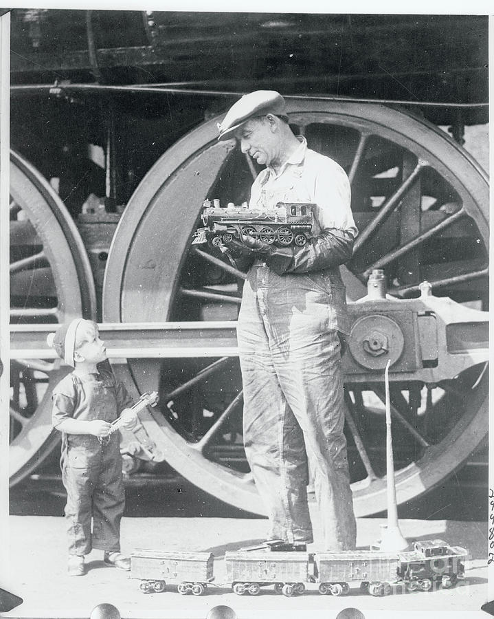 Locomotive Engineer Holding Model Train Photograph by Bettmann