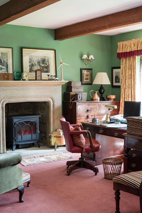 Log Burner In Fireplace And Antique Furniture In Study With Green Walls Photograph by Brian Harrison