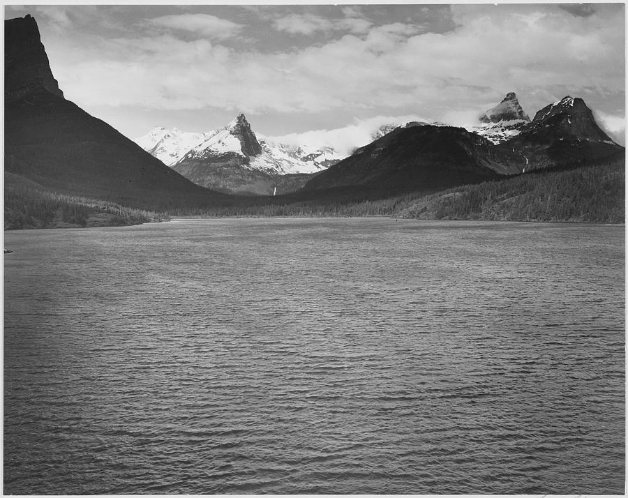 Looking across toward snow-capped mountains lake in foreground St. Marys Lake Glacier National Park Montana. 1933 - 1942 Painting by Ansel Adams