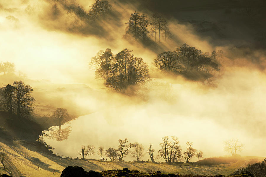 Lake District National Park Photograph - Looking Down Onto Loughrigg Tarn Above Valley Mist Formed By A Temperature Inversion On Loughrigg, Near Ambleside In The Lake District National Park, With Walkers. by Cavan Images