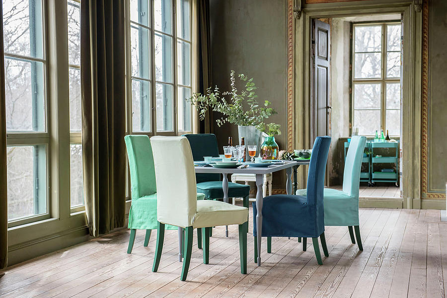 Loosecovered Chairs In Dining Room With Large, Lattice Windows In