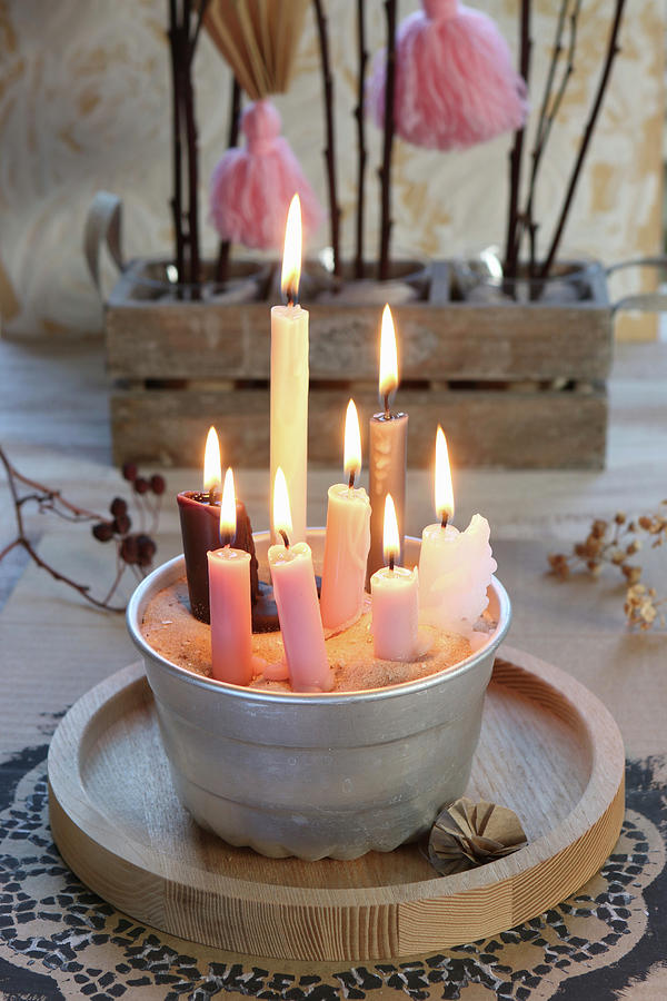 Lots Of Burning Candles In A Bundt Cake Tin Filled With Sand Photograph by Regina Hippel