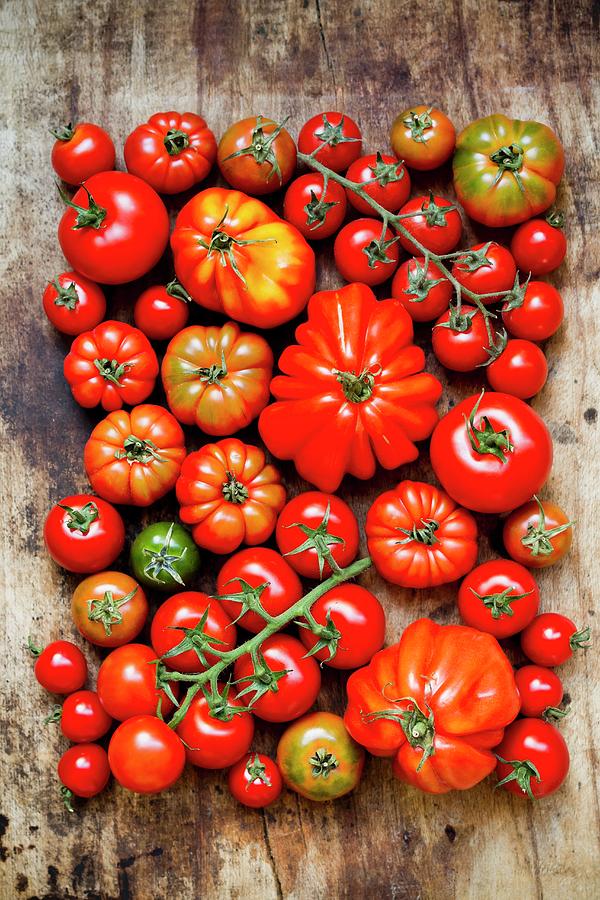 Lots Of Different Tomatoes Are Wooden Surface Photograph by Sporrer/skowronek